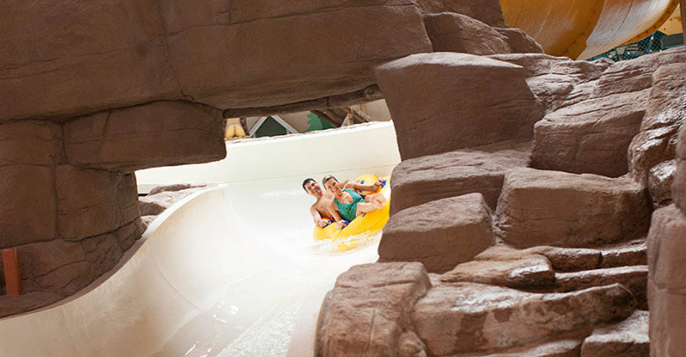 Couple in a double tube zipping down Lookout Mountain water slide at the Great Wolf Lodge Indoor Water Park in Wisconsin Dells 960