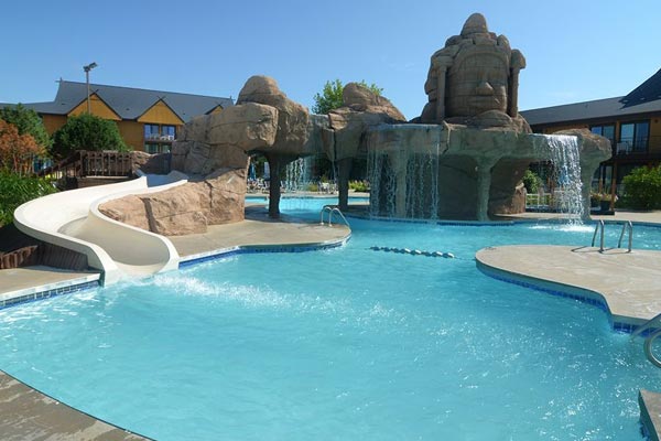 View of the Polynesian Water Park Resort Outdoor Pool with Waterfall and Water Slide 600